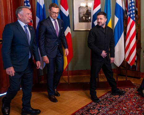 Zelenskyy walks with Finland's president and US envoy Witkoff past national flags in Oslo