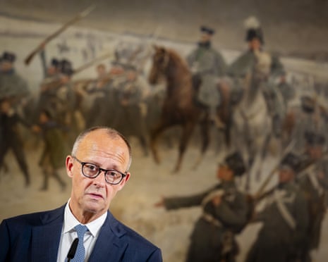 Friedrich Merz speaks at a press conference before a large painting of soldiers and horses
